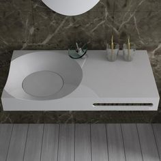 a bathroom sink sitting on top of a counter next to a mirror and toothbrushes