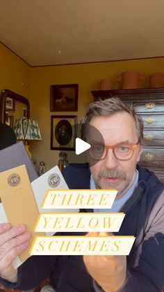 a man holding up three yellow schems in front of his face with the caption'three yellow schems '