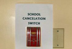 a red switch box sitting on top of a wall next to a sign that says school cancleation switch