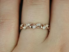 a woman's hand with a diamond ring on it