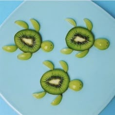 three slices of kiwi sitting on top of each other in the shape of turtles