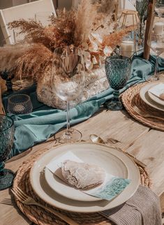 the table is set with dishes and place settings