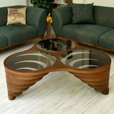 a coffee table made out of wood and glass in the middle of a living room