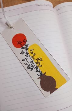 a bookmark with an image of onions and carrots on it, hanging from a string