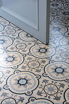 the floor is covered in blue and white tile with an ornate design on it's surface