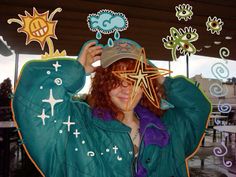 a woman with red hair wearing a green jacket and hat is holding her head in front of her face