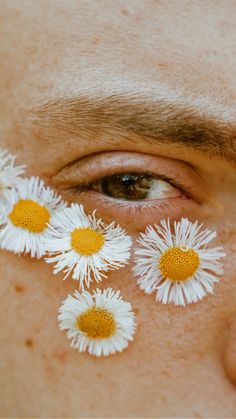 a man with daisies on his face