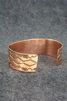 This copper bracelet was made by Navajo silversmith Elaine Tahe. The inside of the cuff is stamped TAHE and copper.Size: 5 7/8" (will fit up to a 6 7/8" wrist)Gap: 1"Width: 3/4Free shipping on all orders! We ship with USPS and always include tracking. All orders ship within a day of payment.Returns are accepted up to 30 days after you receive your order. Just send us a message. Our shop offers cash back or store credit. The item must be returned in new condition. Adjustable Etched Copper Jewelry, Engraved Copper Bracelet Jewelry, Adjustable Etched Bronze Cuff Bracelet, Adjustable Bronze Etched Cuff Bracelet, Adjustable Etched Bronze Bracelets, Engraved Bronze Copper Bracelets, Southwestern Adjustable Gold Bracelets, Adjustable Southwestern Gold Bracelets, Engraved Copper Bracelet