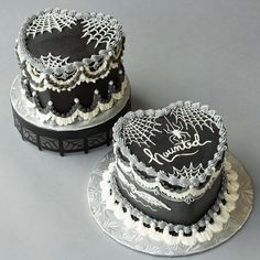 two black and white cakes sitting on top of each other