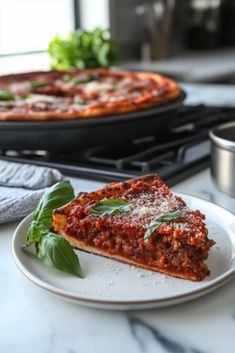 a slice of pizza sitting on top of a white plate next to a pan of pizza