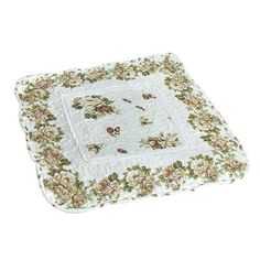 a white and green flowered square pillow on a white background