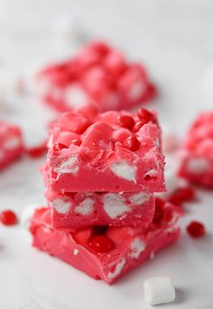 two pieces of red and white cake with marshmallows