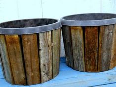 two wooden trash cans sitting on top of a blue floor