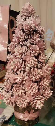 a pink christmas tree is sitting on a table