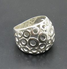 Sterling silver ring 925/1000. Circles band .Stamped 925. Approximate weight 7.3 grams. Top width 1.8cm . All our jewels are made from solid sterling silver 925/1000 and are carefully crafted by hand in our family workshop. We dispatch your orders in 5 working days, worldwide and the postage is $5. We ship registered priority mail. Please allow 5-7 working days for delivery in Europe and 10-15 working days outside Europe. For any questions - please do not hesitate to contact me! Sterling Silver Open Band Ring With 925 Stamp, Sterling Silver Open Band Ring, Sterling Silver Open Band Ring Stamped 925, Sterling Silver 925 Stamped Silver Rings, Sterling Silver Dome Ring With Open Band, Sterling Silver Wide Band Ring Stamped 925, Unique Silver Hallmarked Dome Ring, Sterling Silver Hallmarked Dome Ring, Nickel Free Sterling Silver Wide Band Rings