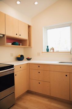 an empty kitchen with wooden cabinets and white counter tops, including a dishwasher