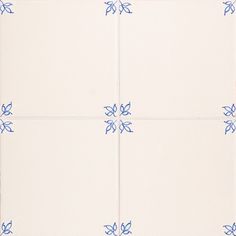 four white tiles with blue flower designs on them