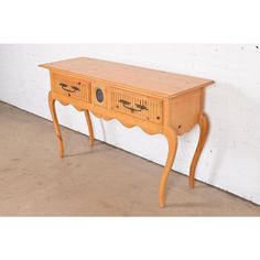 an old wooden table with two drawers