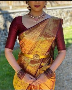 a woman wearing a yellow and red sari