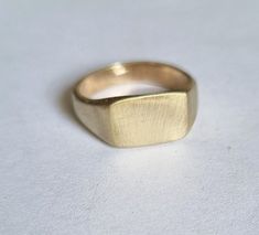 "Classic solid gold signet ring in a rectangular design, modern minimalist pinky ring jewelry for women, available in 9k, 14k, and 18k solid gold.  This handmade signet gold ring is elegant and classic. It was made by carving wax and casting it into gold.  It is available in 9k solid yellow gold, 14k solid yellow, white or rose gold, and 18k solid yellow gold, and in matte or shiny finish.  This ring is very comfortable to wear and great for everyday use, and will never go out of style. It can a Modern Gold Square Signet Ring, Classic 14k Gold Rectangular Initial Ring, Classic Rectangular Signet Ring Stamped 14k, Classic Formal Signet Ring With Simple Design, Classic Yellow Gold Rectangular Initial Ring, Classic Rectangular Yellow Gold Initial Ring, Gold Rectangular Signet Ring Stamped 14k, Square Minimalist Signet Ring For Formal Occasions, Classic 14k Gold Signet Ring With Simple Design