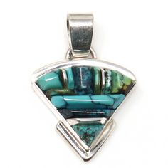 Indulge in the beauty and craftsmanship of Navaho artist John Charlie's cobbled inlay sterling silver pendant. The hallmark, Nataanii, guarantees authenticity. Measuring 1 3/8" in length and 1" in width, this stunning pendant weighs 6.6 grams. The 5mm wide bale adds the perfect finishing touch. Traditional Sterling Silver Inlay Necklaces, Turquoise Pendant Necklace With Inlay, Southwestern Sterling Silver Necklace With Inlay, Southwestern Sterling Silver Inlay Necklaces, Southwestern Turquoise Inlay Pendant Necklace, Sterling Silver Pendant, Sterling Silver Pendants, Hallmark, Silver Pendant