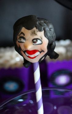 a close up of a cake topper with a clown face on it