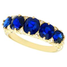 A stunning, fine and impressive antique 3.15 carat Basaltic blue sapphire and 0.08 carat diamond, 15 karat yellow gold five stone ring; part of our antique jewelry and estate jewelry collections. This stunning antique sapphire ring has been crafted in 15 karat yellow gold. The impressive shaped multi-claw, scroll setting displays five graduating oval and round cut Basaltic sapphires displayed in a linear arrangement. The scrolling setting is further ornamented with a single Dutch cut diamond to Sapphire Antique Ring, Ring Antique, Dress Rings, Sapphire Jewelry, Antique Jewellery, Engagement Rings Sapphire, Jewelry Rings Engagement, Antique Rings, Vintage Engagement Rings