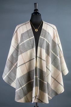 Celebrate the season with this lightweight, and softly brushed lambswool wrap. The neutral hue with accents of gray, tan, and ivory blend perfectly, and the soft wool provides comfort and warmth. Pair it with jeans, a sweater and a pair of boots for a sophisticated and classic look. The high quality construction ensures that this will be your go-to seasonal wrap for years. 100% Brushed Lambswool 52" L x 66" W Dry Clean Only Made in Ireland Ships from the USA Wrap is paired with Open Knot Gold-Pl Cozy Beige Cashmere Outerwear, Cozy Wool Poncho For Fall, Winter Beige Alpaca Poncho, Beige Alpaca Poncho For Winter, Cozy Beige Wool Poncho, Cozy Brown Wool Poncho, Winter Beige Poncho For Cold Weather, Beige Poncho For Cold Weather In Fall, Ruana Wrap