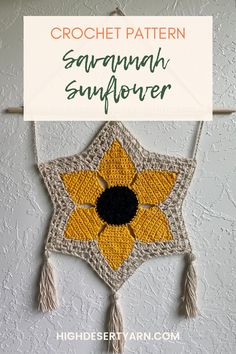 a crochet sunflower hanging on the wall with text overlay that reads, crochet pattern savannah sunflower