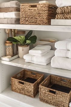 towels and baskets are stacked on shelves in the bathroom, along with other items for storage