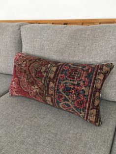 a decorative pillow on the back of a couch