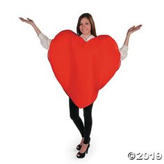 a woman holding a large red heart in her hands