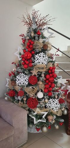 a christmas tree decorated with red and gold ornaments