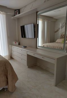 a bedroom with a large mirror on the wall