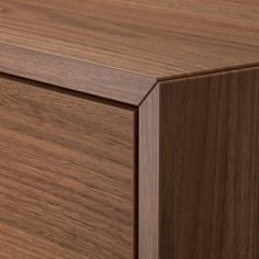 a close up view of the top of a wooden cabinet with wood grained finish