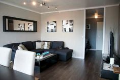 a living room filled with furniture and pictures on the wall