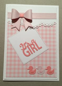 a pink and white card with a bow on the top that says happy girl next to two rubber ducks