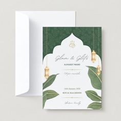 a green and white wedding card with a lantern hanging from the ceiling, on top of a