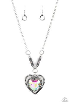 Bordered in spun silver ribbons, an oversized iridescent heart gem is pressed into a silver heart frame below the collar. The flirtatious pendant attaches to silver rings and decorative silver frames dotted in matching iridescent rhinestones, resulting in a dash of vintage inspired romance. Due to its prismatic palette, color may vary. Features an adjustable clasp closure.

Sold as one individual necklace. Includes one pair of matching earrings. Heart Gem, Multi Necklace, Silver Flower Earrings, Palette Color, Party Necklace, Silver Frames, Heart Frame, Rhinestone Ring, Paparazzi Accessories