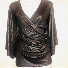 New! Never Been Worn! Gorgeous Gunmetal Gray Shimmery Top With Cold Shoulders.V Neck Blouse.Blouse Gathers On The Side So You Actually Put The Blouse On Over Your Head. Wonderful To Wear To A Holiday Event Or Just With Jeans. 92% Polyester 8% Elastane Shiny Tops For Evening And Party Season, Shiny Top For Evening And Party Season, Evening Shiny Top For Party Season, V-neck Shimmer Tops For Party Season, Glamorous Fitted Shiny Blouse, Elegant V-neck Holiday Tops, Shiny Party Blouse For Fall, Glamorous Shiny Metallic Tops, Metallic V-neck Top For Party