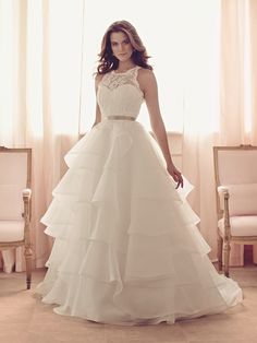 a woman in a white wedding dress posing for the camera