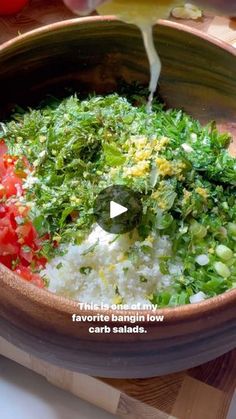 a bowl filled with rice and vegetables on top of a cutting board