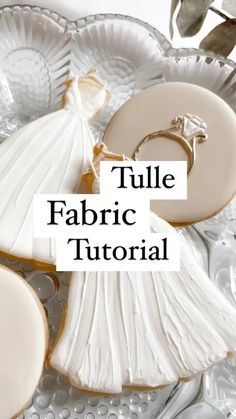 the words tulle fabric are in front of some cookies on a glass platter