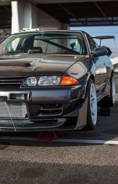 the front end of a car parked in a parking lot