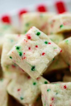 white sugar with green and red sprinkles on it sitting in a bowl