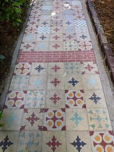 a walkway made out of different colored tiles