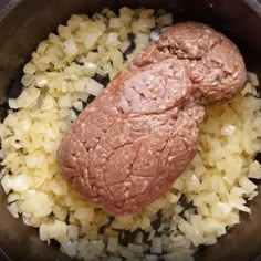 meat and onions cooking in a pot on the stove