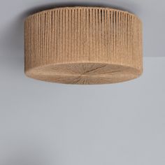 the light fixture is made from wood and has a pleated fabric covering on it