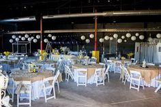 tables and chairs are set up in an industrial setting for a wedding or other function