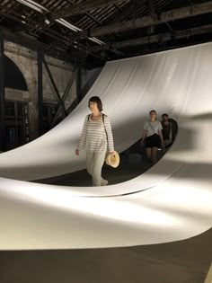 a woman is walking through an art installation